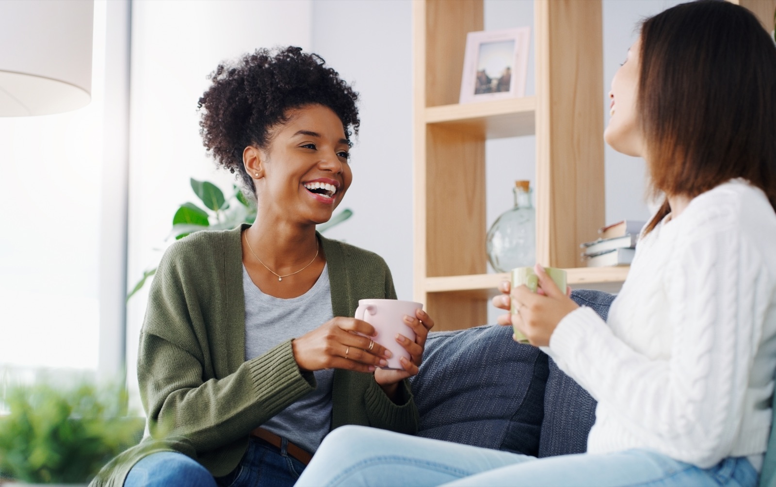 Two friends sharing a conversation over coffee at home